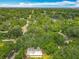 Bird's eye view showing the property surrounded by dense trees and other greenery at 6901 N 19Th St, Tampa, FL 33610