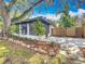 Side patio, lush landscaping, and wooden fence at 6901 N 19Th St, Tampa, FL 33610