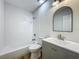 Bright, updated bathroom with tiled shower-tub combination and gray vanity at 6901 N 19Th St, Tampa, FL 33610