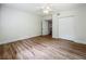 Bedroom with wood-look floors, a ceiling fan and a closet for ample storage at 6901 N 19Th St, Tampa, FL 33610