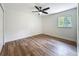 Comfortable bedroom features wood-look floors and a window, providing natural light at 6901 N 19Th St, Tampa, FL 33610
