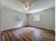 Bright bedroom with wood-look floors and two windows, providing natural light at 6901 N 19Th St, Tampa, FL 33610