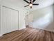 Charming bedroom with wood-look floors, a ceiling fan and a closet at 6901 N 19Th St, Tampa, FL 33610