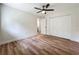 Bright bedroom with wood-look floors, a ceiling fan and a closet for ample storage at 6901 N 19Th St, Tampa, FL 33610
