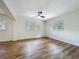 Sunny bedroom showcasing hardwood flooring, fresh paint, and natural light, ideal for peaceful living at 6901 N 19Th St, Tampa, FL 33610