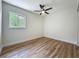 Comfortable bedroom with wood-look floors and a window, providing natural light at 6901 N 19Th St, Tampa, FL 33610