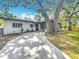 Contemporary home with a concrete driveway, providing ample parking, and appealing exterior with a modern design at 6901 N 19Th St, Tampa, FL 33610