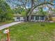 Charming single-story home with a well-manicured lawn and mature trees offering ample shade and curb appeal at 6901 N 19Th St, Tampa, FL 33610