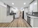 Modern kitchen featuring stainless steel appliances, gray backsplash, and hardwood floors at 6901 N 19Th St, Tampa, FL 33610