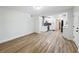 Open concept living room with wood floors leading to kitchen offering space for entertaining and relaxation at 6901 N 19Th St, Tampa, FL 33610