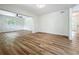 Bright living room with hardwood floors, fresh paint, and a ceiling fan creating a comfortable atmosphere at 6901 N 19Th St, Tampa, FL 33610