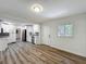 Updated living room with sleek floors, white cabinets, stainless steel appliances, and modern finishes at 6901 N 19Th St, Tampa, FL 33610