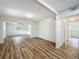 Spacious living room with wood flooring and crisp white walls, offering a bright and airy ambiance at 6901 N 19Th St, Tampa, FL 33610