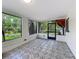 Bright sunroom with decorative tile flooring and large windows providing natural light at 6901 N 19Th St, Tampa, FL 33610