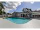 Backyard with pool, adjacent screened-in porch, modern appliances, and wooden pergola at 706 Kingswood Loop, Brandon, FL 33511