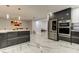 Modern kitchen with stainless steel appliances, sleek cabinetry, and open floor plan at 706 Kingswood Loop, Brandon, FL 33511