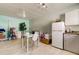 Bright living space with table and chairs, cabinets, and laminate flooring at 706 Kingswood Loop, Brandon, FL 33511