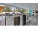 Long, modern outdoor kitchen has stainless steel accents, marble counters, and lots of space at 706 Kingswood Loop, Brandon, FL 33511