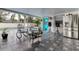 Relaxing screened in patio with view of a refreshing pool, rocking chairs, and modern appliances at 706 Kingswood Loop, Brandon, FL 33511