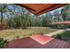 Spacious backyard with a deck, mature trees, and plenty of room for outdoor activities at 7095 South St, Webster, FL 33597