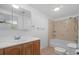 Bathroom features a vanity, toilet, and tub with tile surround at 7095 South St, Webster, FL 33597