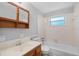 Updated bathroom features a vanity, toilet, and shower with window at 7095 South St, Webster, FL 33597