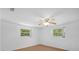 This bedroom features a ceiling fan and two windows for natural light at 7095 South St, Webster, FL 33597