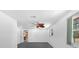 Bright bedroom with natural light, neutral paint, and a glimpse into the adjacent kitchen at 7095 South St, Webster, FL 33597
