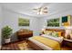 Bedroom features wood flooring, ceiling fan, and staging decor at 7095 South St, Webster, FL 33597