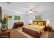 Bedroom offers wood floor, ceiling fan, and stylish staging at 7095 South St, Webster, FL 33597