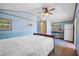 Bedroom features a ceiling fan, a double bed, and an ensuite bathroom at 7095 South St, Webster, FL 33597