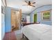 Bedroom featuring a ceiling fan, a double bed, and an ensuite bathroom at 7095 South St, Webster, FL 33597