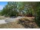 The long driveway leads to a home hidden among mature trees at 7095 South St, Webster, FL 33597