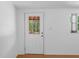 Bright interior view showing a white door with glass and a window bringing in natural light at 7095 South St, Webster, FL 33597