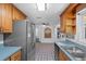 Functional kitchen with light wood cabinets, modern appliances, and charming tile accents at 7095 South St, Webster, FL 33597