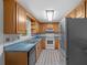 Functional kitchen with light wood cabinets, modern appliances, and charming tile accents at 7095 South St, Webster, FL 33597