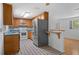 Cozy kitchen featuring classic wooden cabinets, updated appliances, and a breakfast bar at 7095 South St, Webster, FL 33597