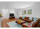 Inviting living room with hardwood floors, a comfortable sofa, and natural light from the window at 7095 South St, Webster, FL 33597
