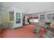 Enclosed Florida room with comfortable seating and ample natural light shining through the screened windows at 7095 South St, Webster, FL 33597