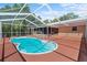 Backyard boasts screened-in pool and spacious patio for entertainment at 7095 South St, Webster, FL 33597