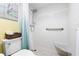 Compact bathroom features white tile shower, matching toilet and tiled floors at 7200 Sunshine Skyway S Ln # 4B, St Petersburg, FL 33711