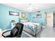 Bright bedroom features a brass bed frame, light blue walls, and modern decor at 7200 Sunshine Skyway S Ln # 4B, St Petersburg, FL 33711