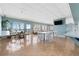 Spacious clubhouse featuring tables, seating, tile floor, and scenic views from the large windows at 7200 Sunshine Skyway S Ln # 4B, St Petersburg, FL 33711