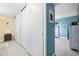 Hallway provides access to storage and bedrooms with light colored floors and modern design at 7200 Sunshine Skyway S Ln # 4B, St Petersburg, FL 33711