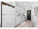 Beautifully remodeled kitchen with white appliances, ample cabinetry, and modern fixtures at 7200 Sunshine Skyway S Ln # 4B, St Petersburg, FL 33711