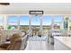 Bright living room with tile floors, comfortable seating, and large windows offering beautiful water views at 7200 Sunshine Skyway S Ln # 4B, St Petersburg, FL 33711