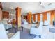 Elegant lobby area with wood paneling, tile flooring, plush seating and a chandelier lit staircase at 7200 Sunshine Skyway S Ln # 4B, St Petersburg, FL 33711