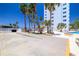 Community pool area with palm trees, shade palapas, and lounge chairs at 7200 Sunshine Skyway S Ln # 4B, St Petersburg, FL 33711