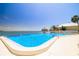 Community pool with Gulf views and lounge chairs at 7200 Sunshine Skyway S Ln # 4B, St Petersburg, FL 33711