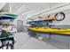 Storage room featuring racks and storage for kayaks, paddle boards, and other sporting equipment at 7200 Sunshine Skyway S Ln # 4B, St Petersburg, FL 33711